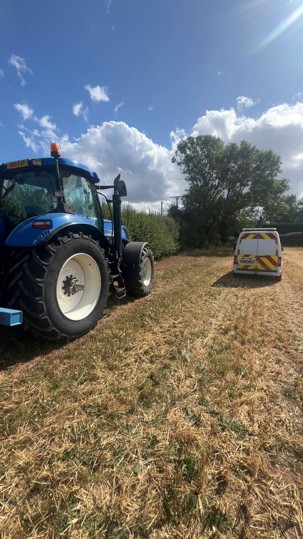 New Holland tractor with mobile service vehicle in the field